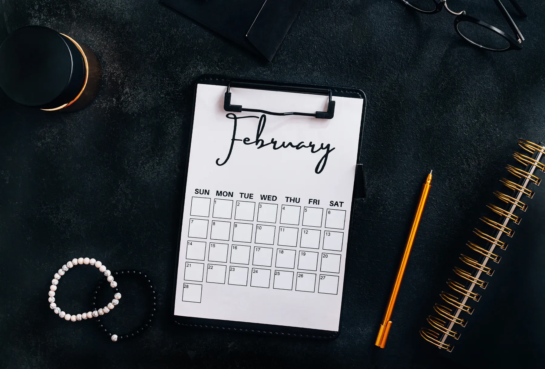 Content calendar on a desk with a pen and notebook