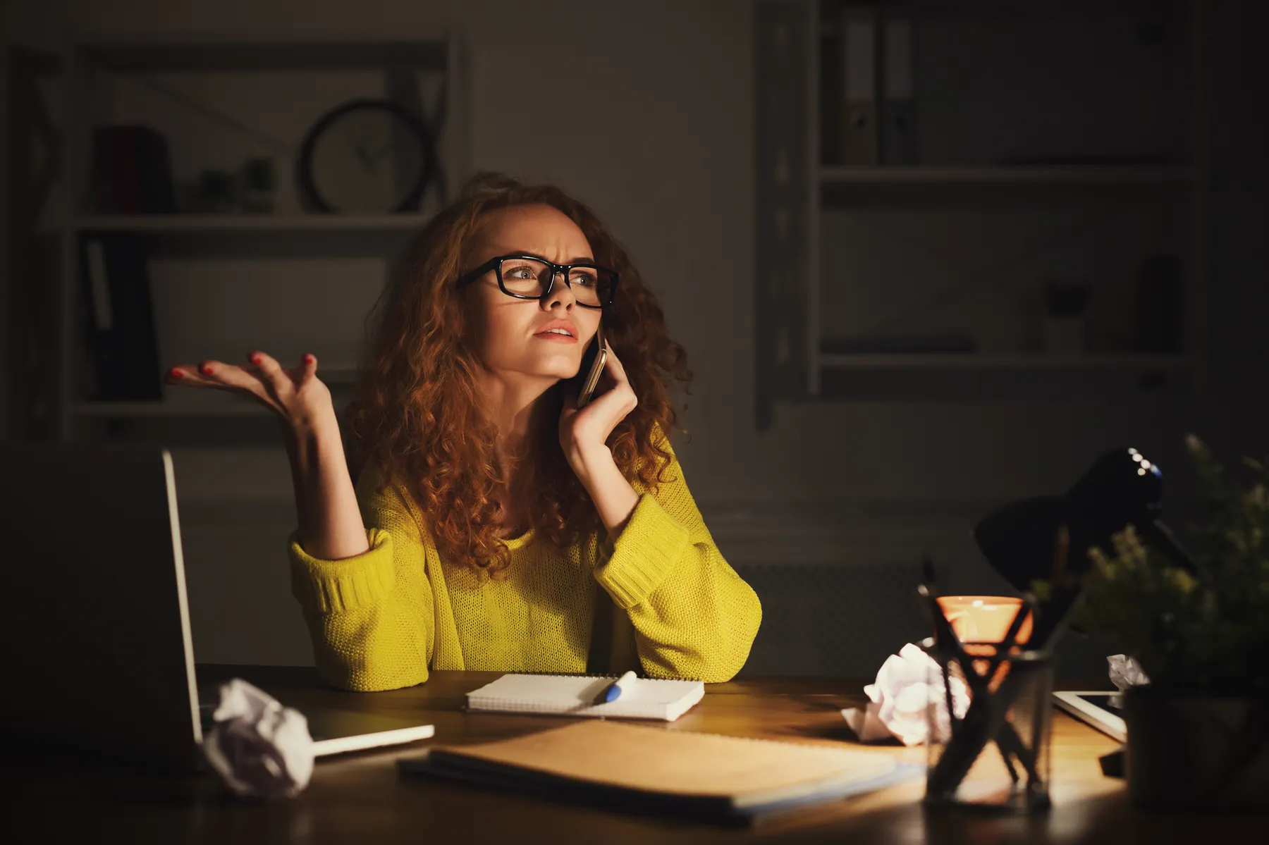 Business owner on the phone at a desk, frustrated with marketing results